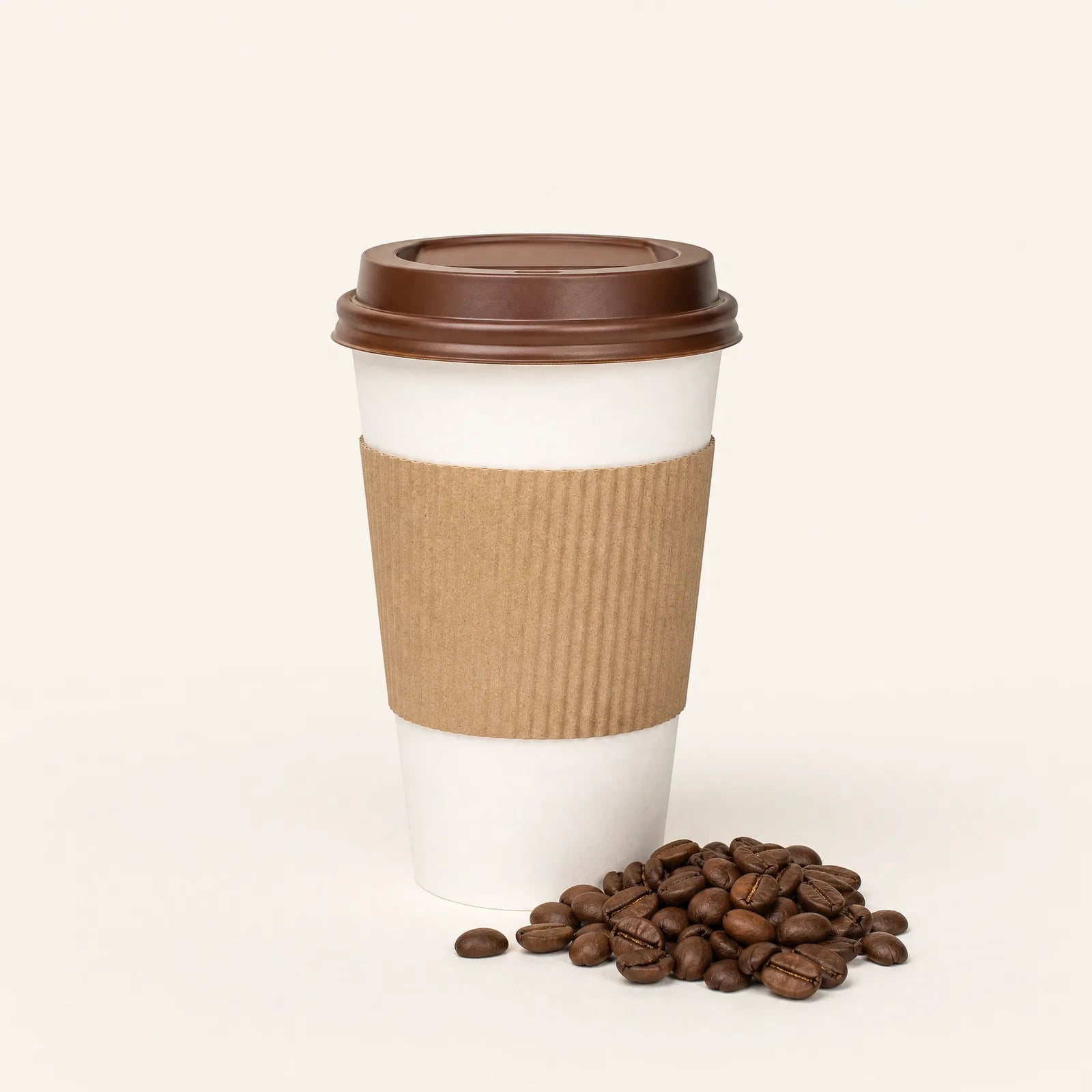 A takeaway coffee in a paper cup beside coffee beans